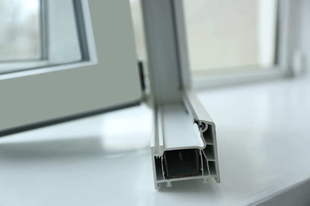 Artisan posant une fenêtre PVC sur un chantier